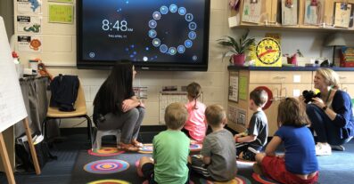 Children utilizing a screen for learning at LeafSpring School