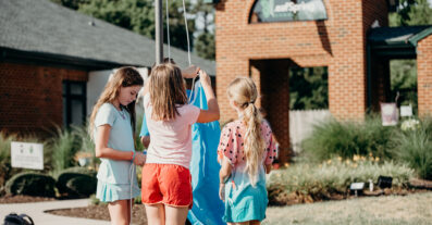 Children raising a flag at LeafSpring School